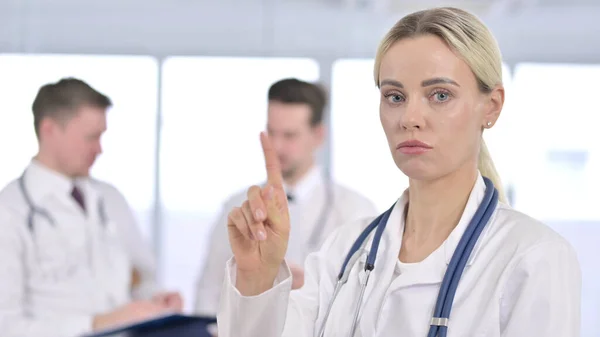 Professional Female Doctor saying No by Finger Sign