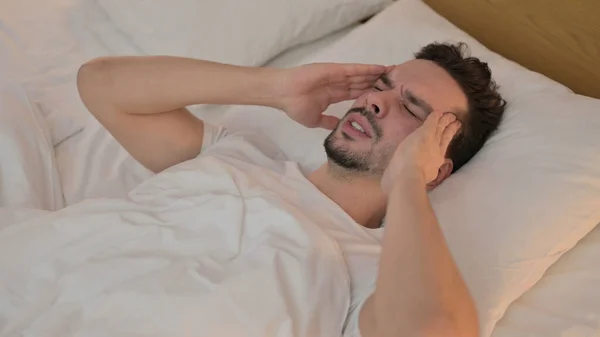 Young Man with Headache Lying in Bed — Stock Photo, Image