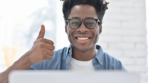 Portrait of Young African Man showing Thumbs Up at Work — Stockfoto