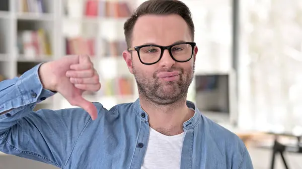 Young Man in Glasses showing Thumbs Down — Stock Fotó