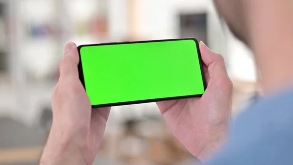 Man Watching Video on Green Smartphone Screen, Chroma Key — Stock Photo, Image