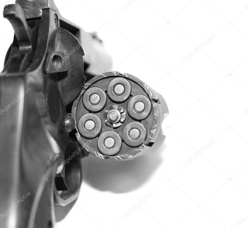 Revolver with bullets close-up isolated on white background / black and white photo