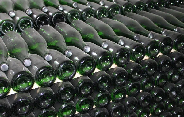 Large stack of wine bottles in winery — Stock Photo, Image