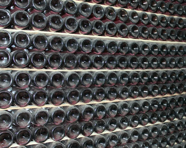 Large stack of wine bottles in winery — Stock Photo, Image