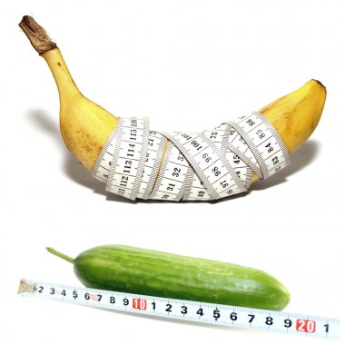 Abstract photo of banana in form of large male penis with good potency and cucumber in form of large male penis with bad potency isolated on white background