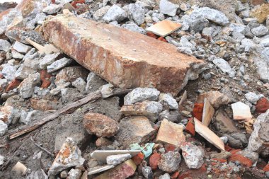 Construction waste with elements of and destroyed old structures at municipal landfill