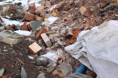 Construction waste with elements of and destroyed old structures at municipal landfill