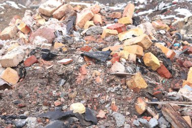 Construction waste with elements of and destroyed old structures at municipal landfill