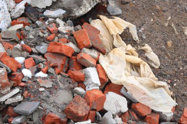 Construction waste with elements of and destroyed old structures at municipal landfill