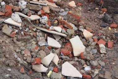 Construction waste with elements of and destroyed old structures at municipal landfill