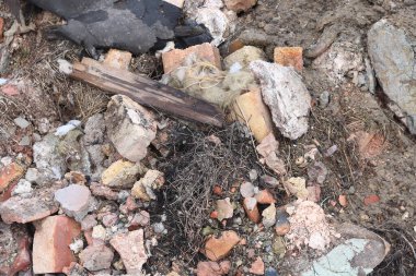 Construction waste with elements of and destroyed old structures at municipal landfill
