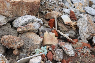 Construction waste with elements of and destroyed old structures at municipal landfill