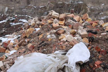 Construction waste with elements of and destroyed old structures at municipal landfill