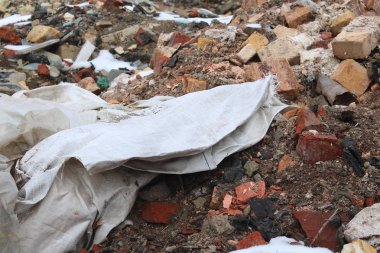 Construction waste with elements of and destroyed old structures at municipal landfill