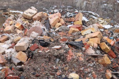 Construction waste with elements of and destroyed old structures at municipal landfill