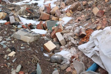 Construction waste with elements of and destroyed old structures at municipal landfill