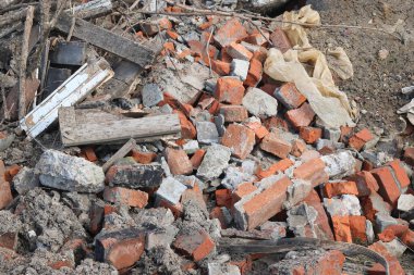 Construction waste with elements of and destroyed old structures at municipal landfill