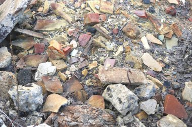 Construction waste with elements of and destroyed old structures at municipal landfill