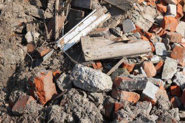Construction waste with elements of and destroyed old structures at municipal landfill