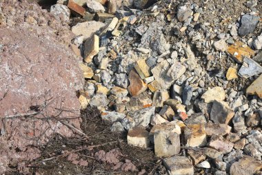 Construction waste with elements of and destroyed old structures at municipal landfill