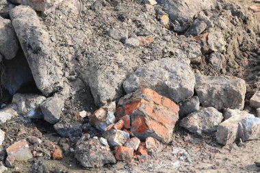 Construction waste with elements of and destroyed old structures at municipal landfill