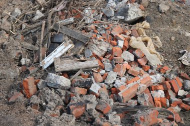 Construction waste with elements of and destroyed old structures at municipal landfill