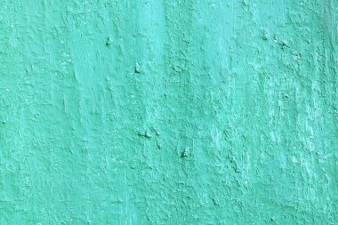 Eski, pürüzlü bir yüzeyi olan eski yeşil boyalı, eski ve pürüzlü bir yüzeyde yeşil rengin çizgileri ve pürüzlü dokusuna sahip güzel, eski yeşil bir arka plan.