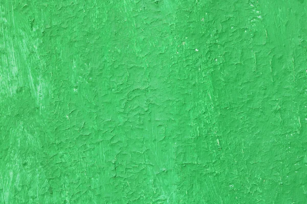 Beautiful vintage green background with old green paint with a rough surface, streaks and uneven texture of green paint on an old rough surface