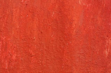 Yüzeyi pürüzlü eski kırmızı boyalı güzel bir klasik arka plan, eski pürüzlü yüzeyde kırmızı boya izleri ve pürüzlü dokuları var.