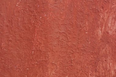 Yüzeyi pürüzlü eski kırmızı boyalı güzel bir klasik arka plan, eski pürüzlü yüzeyde kırmızı boya izleri ve pürüzlü dokuları var.