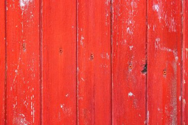 Kırmızı boyalı ve dağınık ahşap tahtalardan oluşan eski bir arka plan.