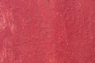 Yüzeyi pürüzlü eski kırmızı boyalı güzel bir klasik arka plan, eski pürüzlü yüzeyde kırmızı boya izleri ve pürüzlü dokuları var.
