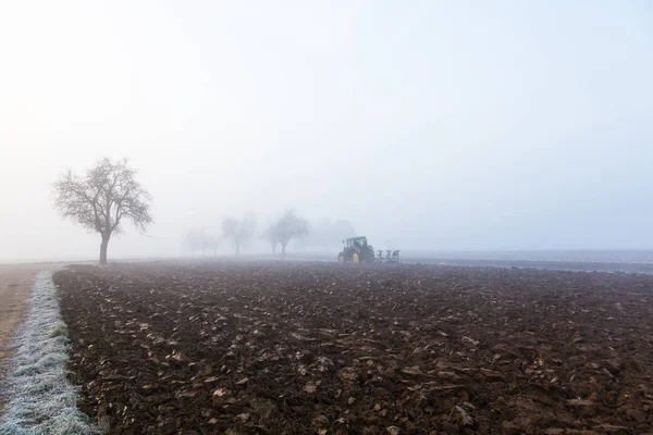 Plowing on foggy day — Stock Photo, Image