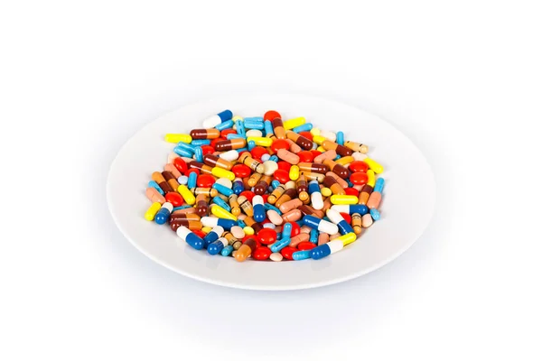 Pillole e capsule su un piatto — Foto Stock