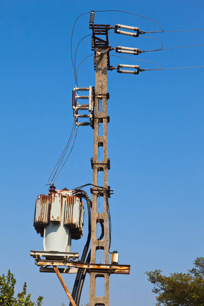 old power transformator against blue sky