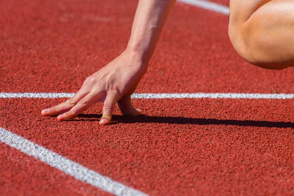 Start line in a stadium with hands — Stock Photo, Image