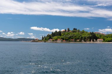 Landscape of mountains, sea and the small towns in the Boka Kotor bay of the Mediterranean Sea sunny day and white clouds. Montenegro.