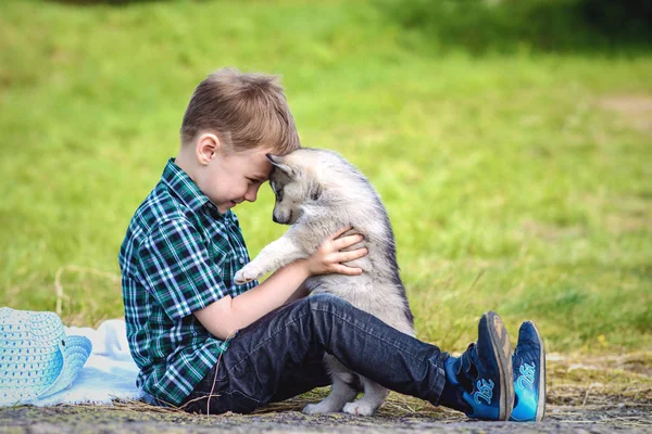 Le garçon avec le chiot touffu — Photo