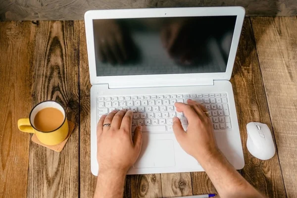 Erkekler ellerini dizüstü bilgisayar ile