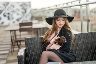 Kız şapka çapında ekledi ve Cape Restoran balkonda oturup