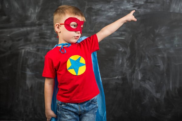 boy superhero in a blue Cape red mask and a red t-shirt with a star