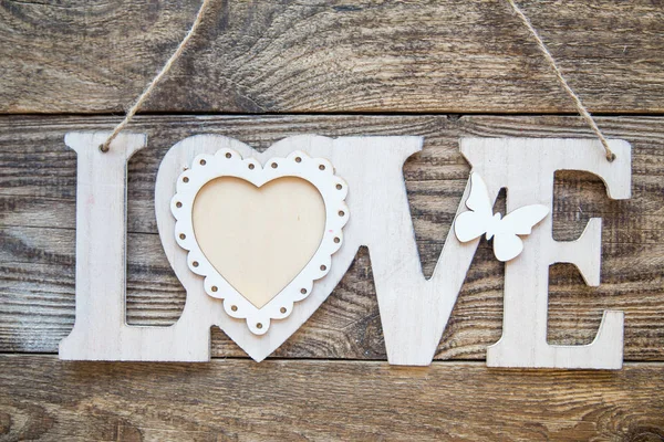 white love letter with heart on a wooden background