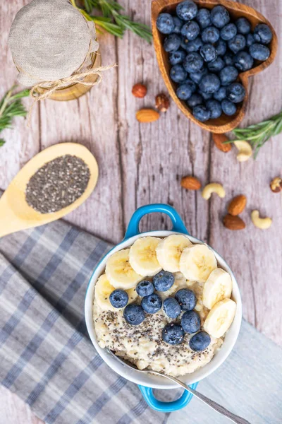 Rustic Breakfast oatmeal with berries and banana with Chia seeds top view — Stock Photo, Image