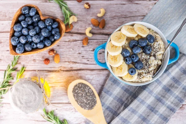 rustic Breakfast oatmeal with berries and banana with Chia seeds top view