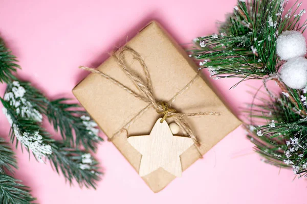 craft gift on pink background fir branches