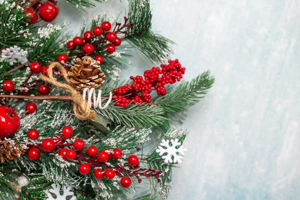 Snow-covered Christmas fir branches on a blue background — Stock Photo, Image