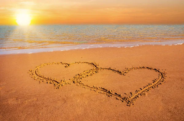 Zwei Herzen auf Sand am Strand — Stockfoto