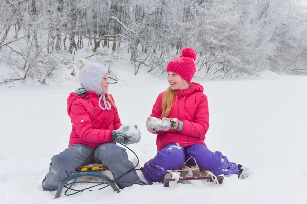 Girls enjoying day playing in winter forest — Stock Photo, Image