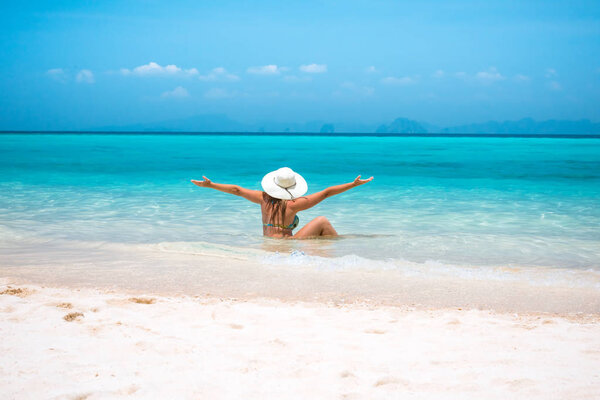 woman in straw hat resting tropical Thailand beach