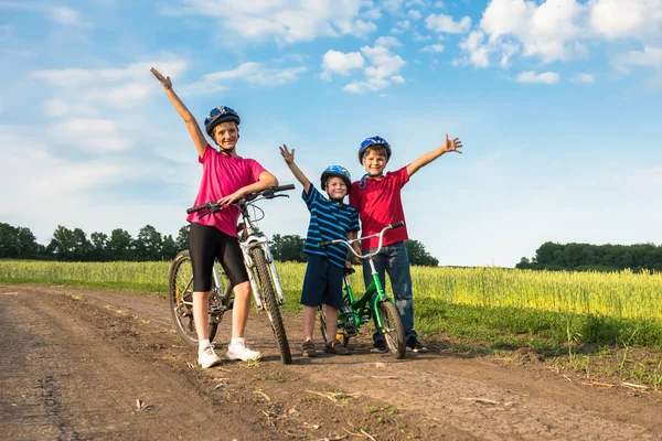Sporty children in helmets with bikes — Stock Photo, Image